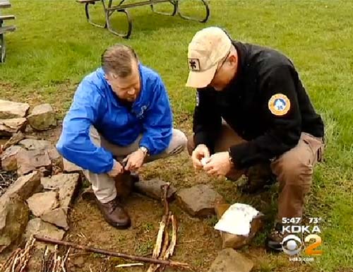 Erik showing David Highfield of WTAE news how to start a fire