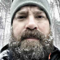 J.C. McGreehan with gray hat and beard with snow on it